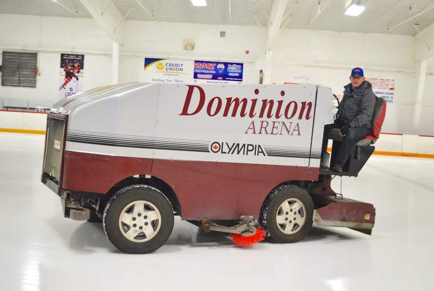 John Wadden, manager of Dominion Arena, cleans the ice with the Olympia resurfacer, which is 22 years old and is being replaced.