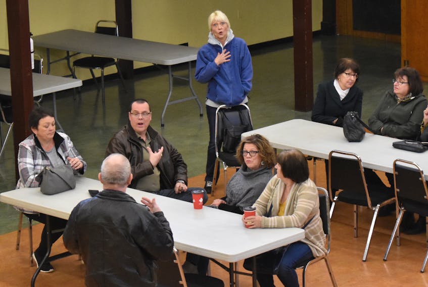 Coxheath resident and self-described health-care activist Barb Chiasson, standing top centre, reacts to comments made at a public health care meeting at the Reserve Mines fire hall on Sunday. The meeting, organized by the Cape Breton chapter of a group called Healthcare Crisis Nova Scotia, attracted fewer than 20 people.