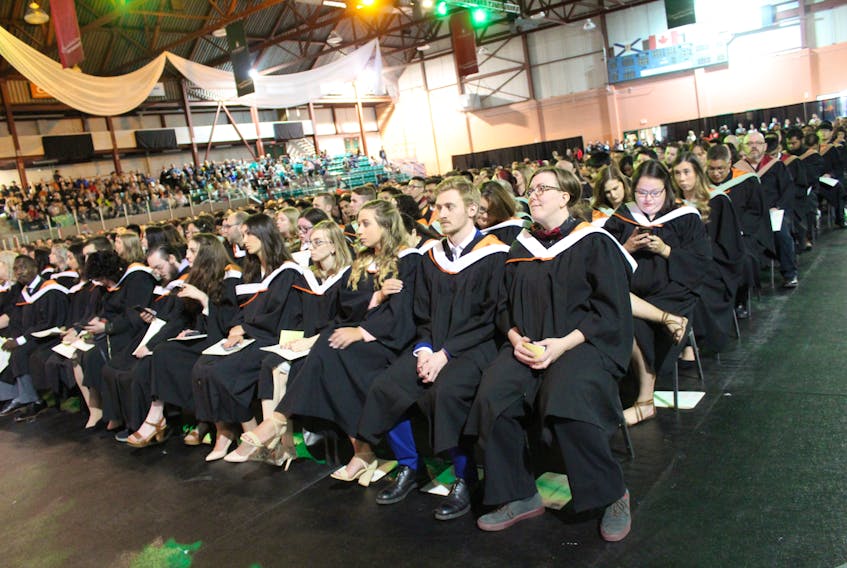 Cape Breton University’s first graduate of the day, Zabrina Downton, far right, smiled while waiting to walk across the stage at the Canada Games Complex. In total, more than 760 graduates received degrees, diplomas or certificates at Saturday’s ceremony.
