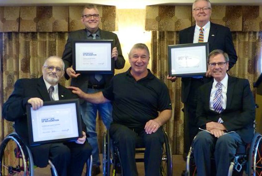 Rick Hansen, front row centre, presented the Rick Hansen Difference Maker Award to the Municipality of the County of Inverness in Truro recently. Shown here left to right, front row, are Inverness Coun. Laurie Cranton, Hansen and Gerry Post, executive director of Nova Scotia’s Accessibility Directorate. Back row, left to right, are Waye Mason, president of the Nova Scotia Federation of Municipalities and Halifax city councillor, and Wolfville Mayor Jeff Cantrell, who also accepted a Hansen award for his town’s efforts in making Wolfville more accessible.
