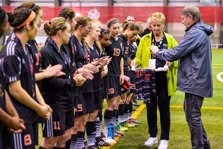 Members of the Cape Breton Capers women’s soccer team line up to accept their silver medals after losing 1-0 in the final game of the U Sports national championship played in Winnipeg, Man., Sunday. Head coach Ness Timmons said while the players were disappointed, they have nothing to be ashamed about and had what he called a ‘super season.’ (JEFF MILLER/U SPORTS)