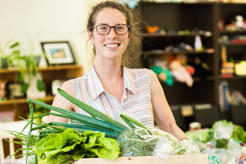 Chloe Donatelli, a volunteer with the Pan Cape Breton Food Hub Co-op, is seen carrying a crate this season. The food hub has had $120,000 in sales for 2017 and has expanded to Inverness. (PHOTO CREDIT MARGARETJOURDAN STUDIO)