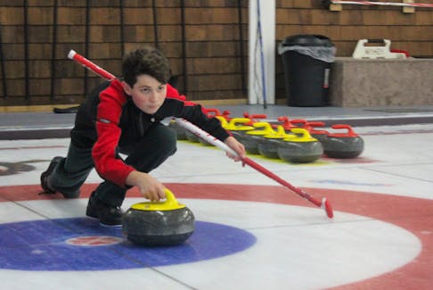 Evan Penney prepares to release a rock during a session of the Alpha/Junior curling program on Monday, Oct. 29, at the Sydney Curling Club.