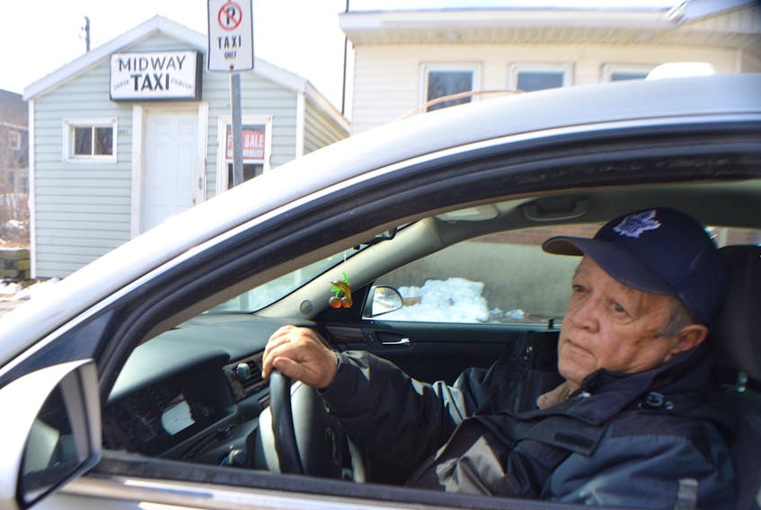 Dan McEachern, a 25-year driver with Midway Taxi, parks in front of the business on Plummer Avenue in New Waterford. The taxi company is for sale.
