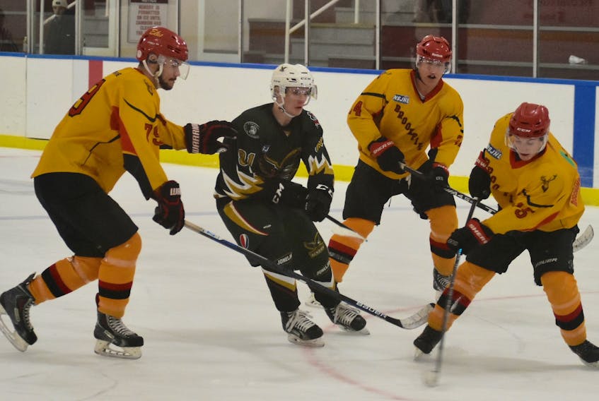 Eskasoni Junior Eagles forward Devan Whitty, second from left, finds himself surrounded by a herd of Elks while mounting an offensive foray in the first period of Sunday’s Nova Scotia Junior Hockey League game against the visiting Brookfield Elks at the Dan K. Stevens Memorial Arena. The trio of Elks include Denver Donnelly (79), Willem Schenkels (24) and Jacob Deveau (15). Eskasoni won the game, 7-1.
