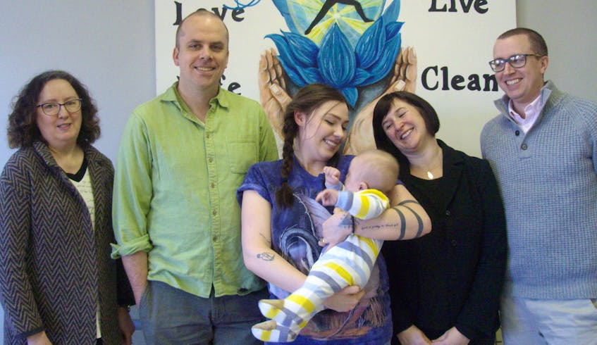 Left to right, Community Cares CEO Dorothy Halliday, Ryan Veltmeyer, Jennifer Hubbert with baby Elliot, Ardelle Reynolds and Mike Targett. Veltmeyer, Hubbert, Reynolds and Targett co-ordinate programs at Community Cares Youth Outreach in Sydney Mines.