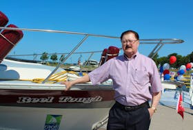 Reg Bonner, a member of the board of directors on the Royal Cape Breton Yacht Club, stands next to his boat, Reel Tough, on the new floating dock that was assembled last week. The finger piers will accommodate between 25 to 30 small pleasure craft. On Monday, Sydney-Victoria MP Mark Eyking announced a federal grant of $173,000 toward the total cost of the estimated $430,000 project.