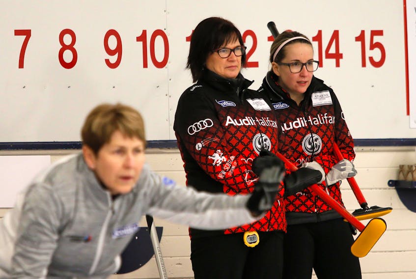 Third Christina Black of Sydney, right, speaks with skip, Mary-Anne Arsenault, during action at the Scotties Tournament at the Dartmouth Curling Club, Jan. 10.