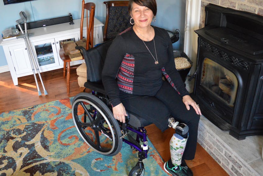 Carol Langille sits in the living room of her Sydney River home, proudly showing off one of her new computerized prosthesis she can now use thanks to the osseointegration surgery she had in Australia in February. The married mother had her right leg amputated above the knee in 2014 after a motorcycle accident.
