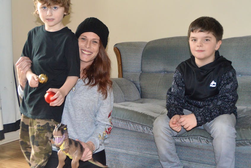 Holly Browner, 35, of Sydney relaxes with two of her three sons, including Isaac, 5, left, and Cody, 7. Browner said Isaac is severely autistic and has been on a list for life-changing assistance with the Early Intensive Behavioural Intervention program, but if he doesn’t get into the program soon, he will not be eligible. Browner said her autistic son, Jake, now 10, went through the program when he was three to four years old and it changed his life.