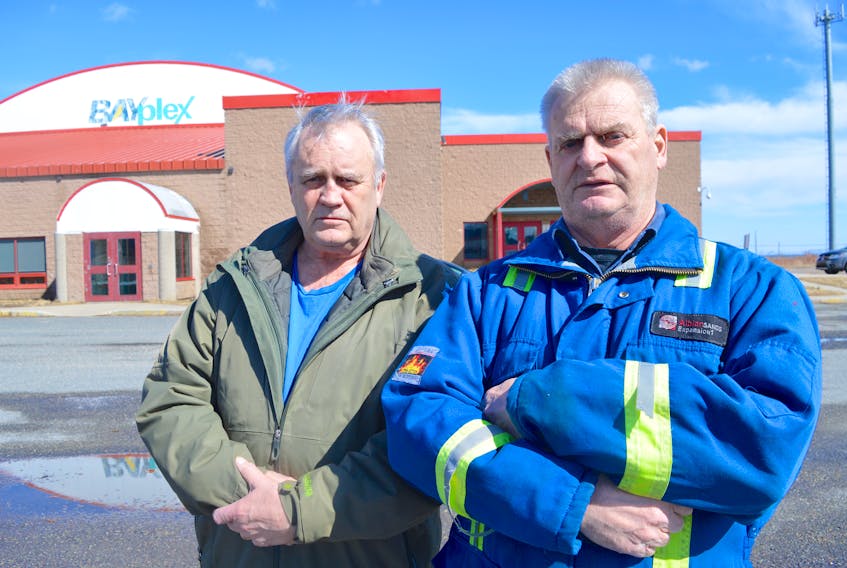 Former Bayplex icemakers Frank Wadden, left, and Wayne Perry stand in front of the of the Glace Bay facility. Wadden and Perry say their future is uncertain now that the Cape Breton Regional Municipality has taken over the Bayplex.