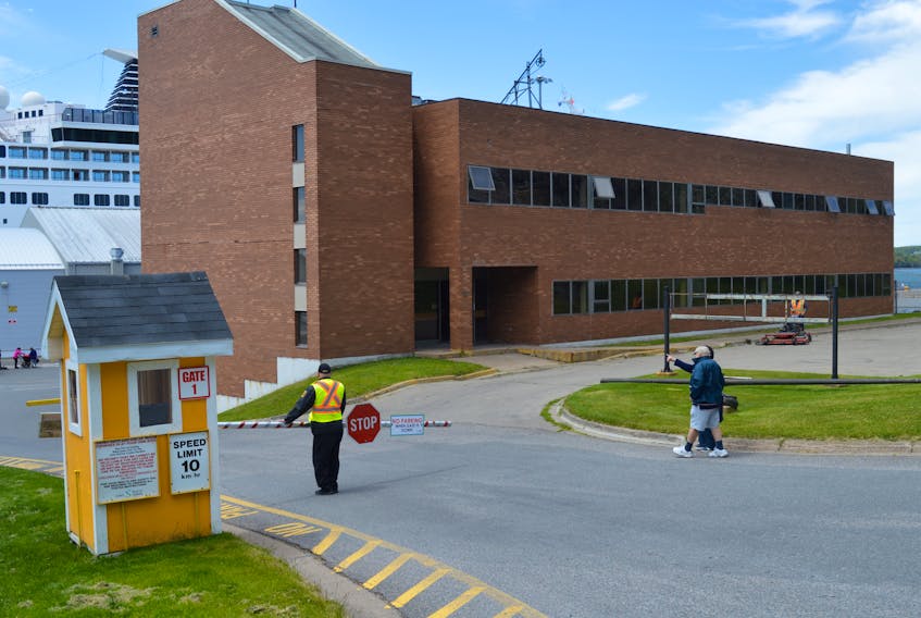 A couple of passengers from the cruise ship Maasdam walk by the former Fisheries and Oceans Canada building at 90 Esplanade in downtown Sydney on Wednesday. The building will have its first occupants in some time when ACAP Cape Breton and the Port of Sydney Development Corp. move into the first floor of the building this summer.