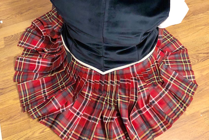 Kathleen Higgins, owner of Higgins School of Highland Dance in Dartmouth, shows off the kilt she will be wearing when she dances for Queen Elizabeth at Balmoral Castle in Scotland. The kilt, made by Deana Lloy of Sydney-based Red Label Tartans, is made with the Behind the Red Curtain tartan that Lloy designed for Glace Bay’s Savoy Theatre in 2017.