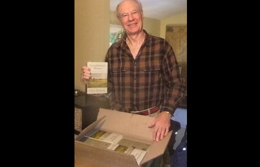 Author Clive Doucet is shown with a box of his latest book, “Grandfather’s House.”