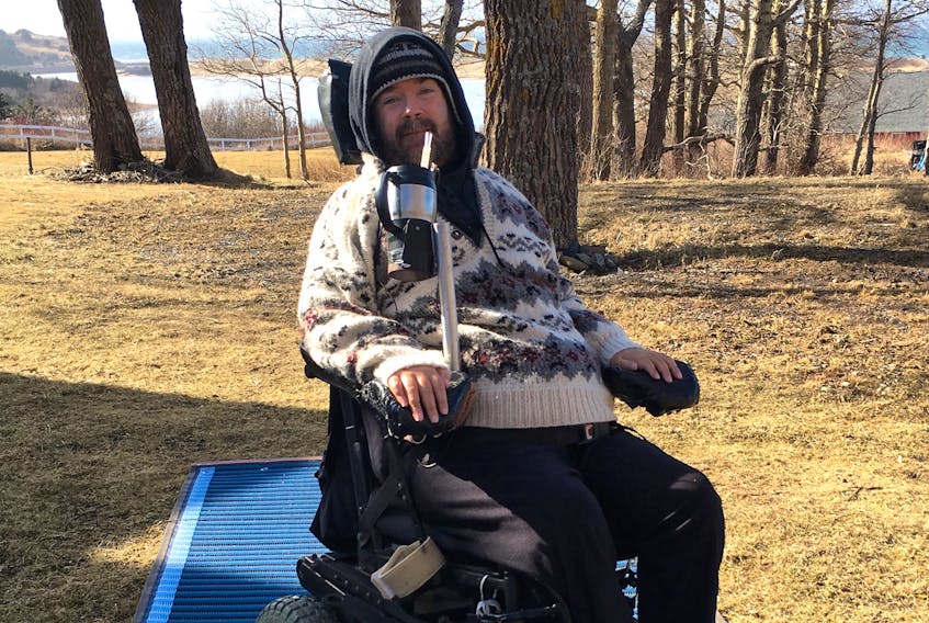 Callum MacQuarrie smiled from his wheelchair on top of some Mobi-Mats. The Inverness man is a member of the committee that is working towards making Inverness Beach fully accessible to wheelchairs and walkers.