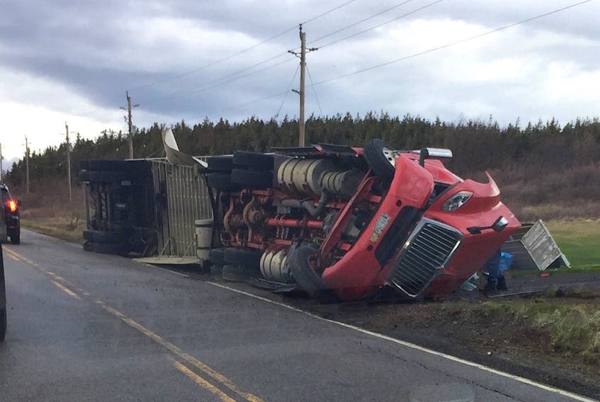 A tractor-trailer was flipped onto the side of the road Wednesday morning by les suêtes winds on the western coast of Cape Breton Island. A local councillor says residents are calling for signage and other protocols to ensure safe passage for high-sided vehicles.