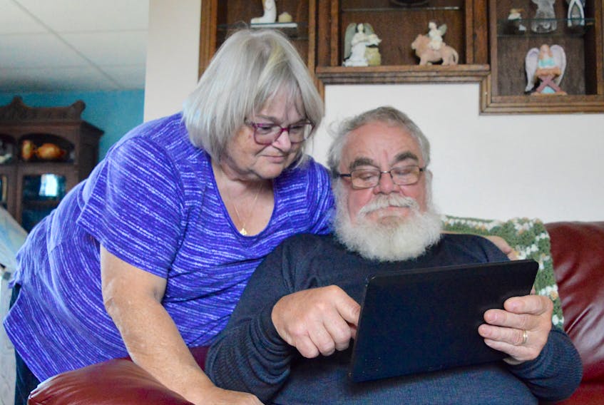 Beth Hazelhurst looks on as husband Gerald shows her photographs he took while recently volunteering with the Canadian Red Cross in North Carolina. Hazelhurst was part of the humanitarian organization’s assistance efforts after the Carolinas were inundated by flooding in the aftermath of Hurricane Florence.