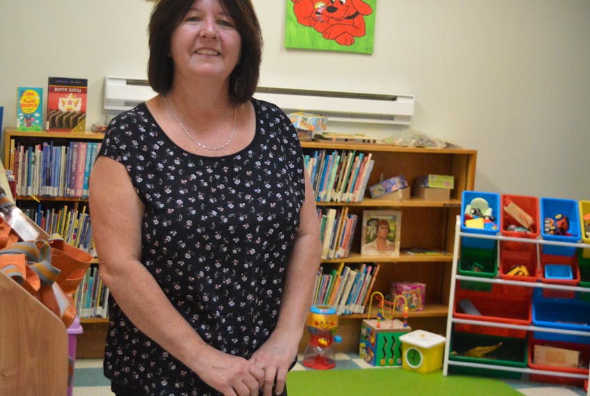 Janet Rizzo stands inside the children’s play area of the New Waterford Library recently. For the past 34 years, Rizzo has been a library clerk and a driving force behind adult and children programs at the library.