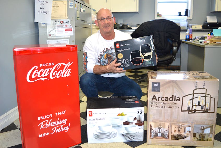 John Wadden, manager of the Dominion Arena, shows items which will be auctioned off during the arena’s 14th annual auction and dance on Feb. 3.