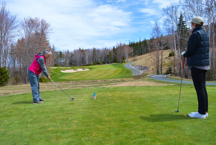Debi Sullivan watches as Elizabeth Buffett of Sydney River takes her shot at No. 11 at The Lakes at Ben Eoin Golf Club and Resort on Tuesday. An injunction hearing began Thursday at the Nova Scotia Supreme Court in Sydney into the Cape Breton Ski Club’s application to stop the transfer of the golf course to the Ben Eoin Development Group Inc.