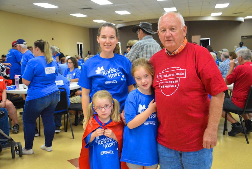 Frank Andrews, right, stands with his daughter, Junell Andrews (left) and his granddaughters, five-year-old Holly Andrews-Sidney (in front of Junell) and seven-year-old Clara Beth Andrews-Sidney at the Grand Lake Road Firehall on Sunday. They were there for the annual Parkinson’s SuperWalk which was dedicated to the memory of Frank’s wife, Marion Andrews, who died in August, shortly after the couple’s 46th wedding anniversary.