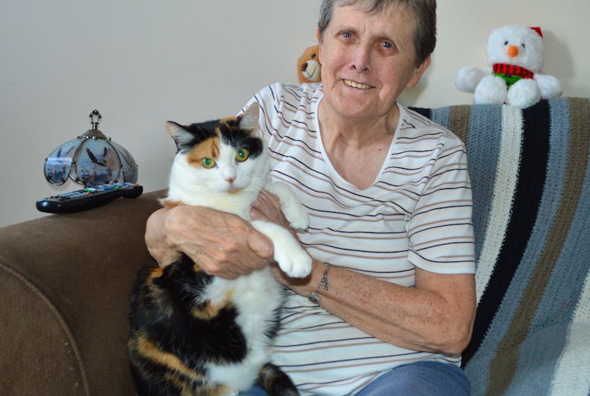 Judy James of Sydney cuddles her beloved cat Jenny in her home on Alexandra Street in Sydney. James said her company usually consists of homecare and VON, and she spends Christmas alone.