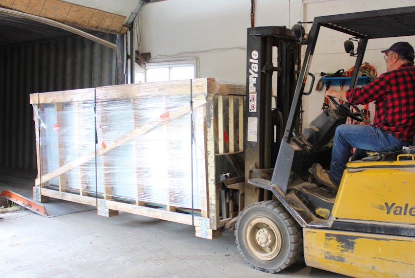 Advanced Glazings Ltd. forklift operator John White prepares the final shipment of the Solera brand of windows to Kuwait University at the company’s manufacturing plant in Sydney, Monday. The 18-month project involved moving 1,126 glazing units in 20 freight shipping containers to the Middle Eastern country.