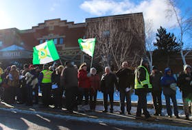 An estimated 100 people stood in front of the Cape Breton Regional Hospital Thursday morning to protest emergency room closures, long wait times, and the lack of doctors in Cape Breton.