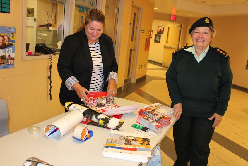 Civilian instructor Denise Cann, left, and Commanding Officer Cindy Tiller from 2878 Glace Bay Army Cadets, set up an information booth at Oceanview Education Centre in Glace Bay on Monday. The unit is hoping to recruit 10 new cadets this month.