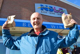 Cape Breton Post reporter David Jala holds up his legally purchased cannabis products at the NSLC’s Sydney River outlet on Wednesday. It was first day the sale of cannabis was legal in Canada and Jala embarked on a mission of reporting on the historic occasion through a first-person account of purchasing marijuana products in Cape Breton.