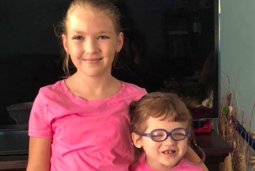 Norah Cameron-Ranni, right, and her older sister Alyssa Cameron were dressed for Pink Shirt Day on Sept. 13. When Norah has to travel with their parents to Toronto for medical appointments, Alyssa stays home with family.