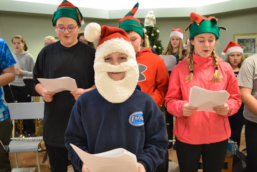 Ty Oliver, front, a Grade 6 student of Oceanview Education Centre in Glace Bay and a member of the Peer Helpers group, sings Christmas songs to residents of Taigh Na Mara veterans’ home and long-term care facility, along with some other members of the group including, in back from the left, Steven MacKenzie, a Grade 8 student, Grain Reid, Grade 6, Rebecca MacMullin, Grade 8.