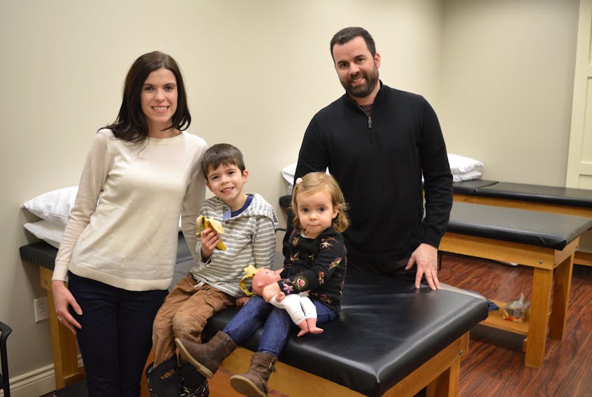Melissa McDonough-Howley and her husband Brian Howley of Sydney, owners of Cabot Physiotherapy and Massage Therapy Clinic in Sydney River, are seen here with their children Evan, 3, and Kate 2, in one of the physiotherapy rooms in their second location on Commercial Street in Glace Bay. The Howleys say opening clinics in Cape Breton, where they both grew up, is a dream come true.