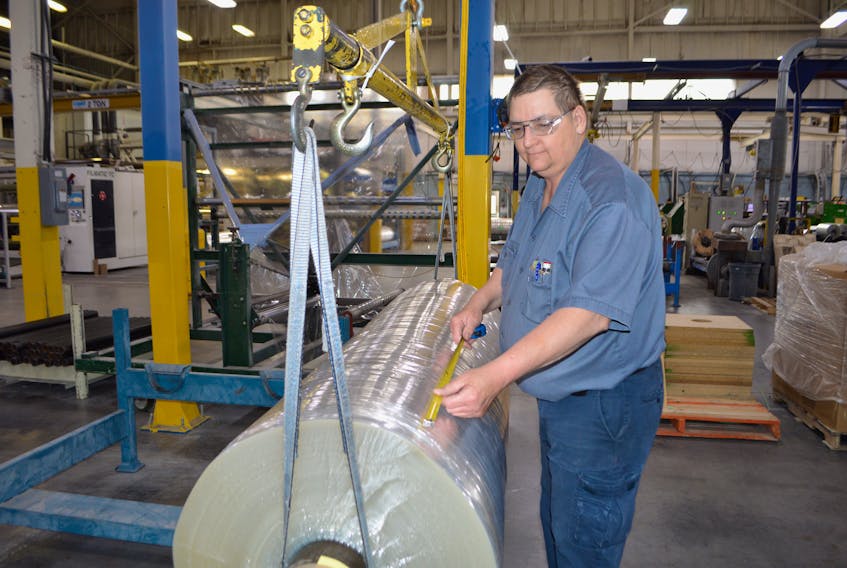James Black, a process operator for Copol in North Sydney, cuts plastic rolls for customers. Copol is one of six small businesses across Canada to receive $150,000 funding for research to replace nonrecyclable products currently used to make plastic.