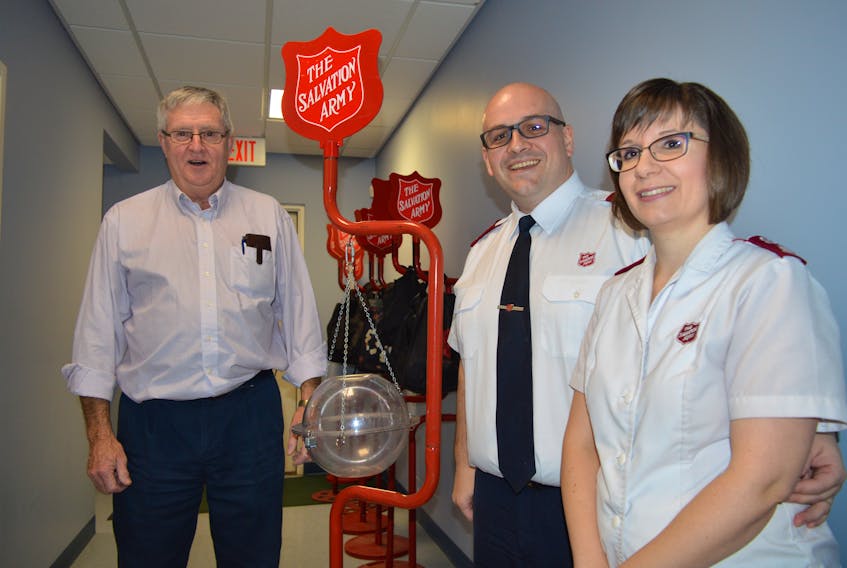 Preparing to distribute Salvation Army kettles are Sandy Beaton, kettle co-ordinator, Corey Vincent and Charlene Vincent.