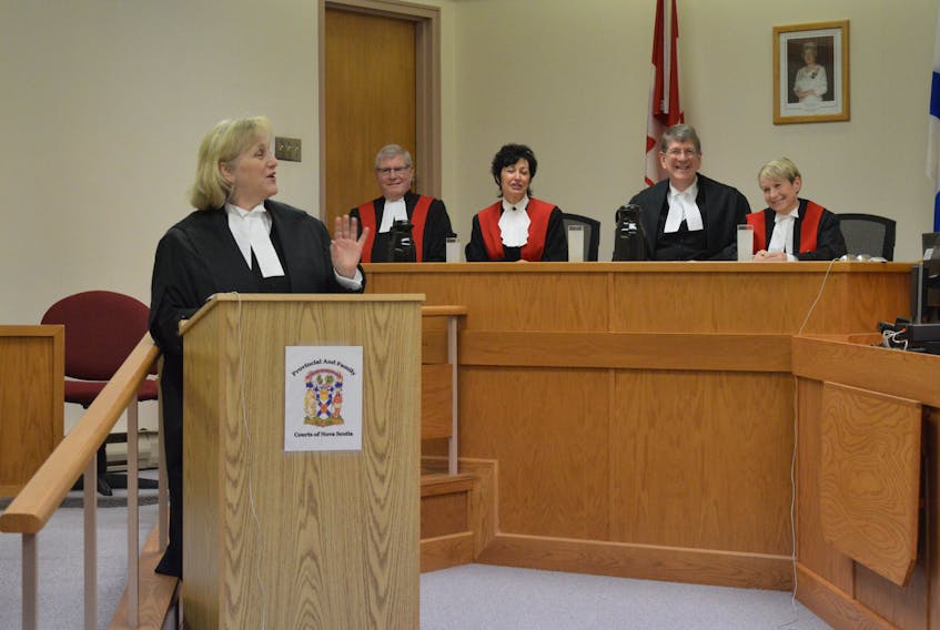 Cape Breton’s chief Crown attorney Kathryn Pentz, foreground, delivered an address during the swearing in of new provincial court Judge Diane McGrath, right.