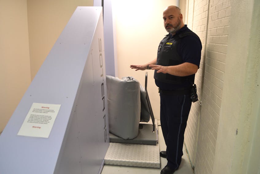 Jason Weldon, security risk officer at the Cape Breton Correctional Centre in Gardiner Mines, demonstrates the facility’s new body scanner with a mattress. The ultimate goal of the body scanner — used for inmates as well as objects like mattresses, clothing and footwear — is to eliminate contraband being brought in the system and make strip searches less intrusive.