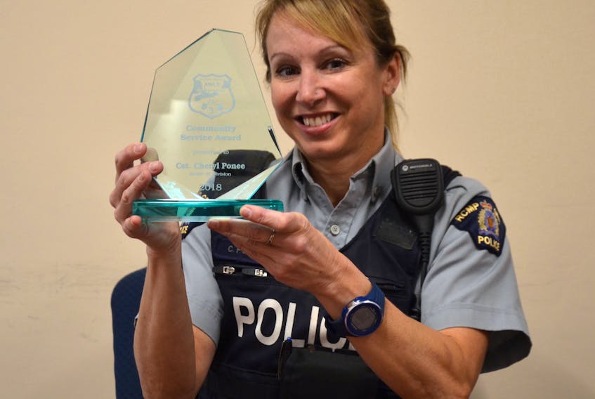 Annapolis District RCMP Const. Cheryl Ponee holds the community service award she was presented by the Atlantic Women in Law Enforcement during a gala ceremony in Moncton earlier this month. She works with school children as an RCMP member and in the community through fitness classes and as part of a dog rescue group.
