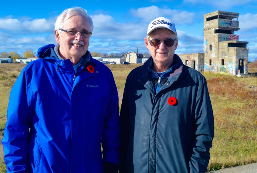 Atlantic Memorial Park committee members Cyril Aker, left, and Brian Ferguson stand in the foreground of the command post at the Chapel Point Battery site in Sydney Mines. A recently completed study said the proposed $15-25 million project is a feasible undertaking.