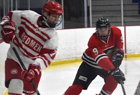 In this file photo, Ethan Stanwick of the Riverview Redmen, left, rims the puck around the boards as he’s chased by David Beaton of the Glace Bay Panthers during Cape Breton High School Hockey League action earlier this year at the County Recreation Centre in Coxheath. Riverview High School will be removing the name “Redmen” from its hockey program as the school prepares to re-brand its sports teams.