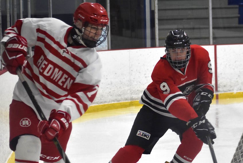 In this file photo, Ethan Stanwick of the Riverview Redmen, left, rims the puck around the boards as he’s chased by David Beaton of the Glace Bay Panthers during Cape Breton High School Hockey League action earlier this year at the County Recreation Centre in Coxheath. Riverview High School will be removing the name “Redmen” from its hockey program as the school prepares to re-brand its sports teams.