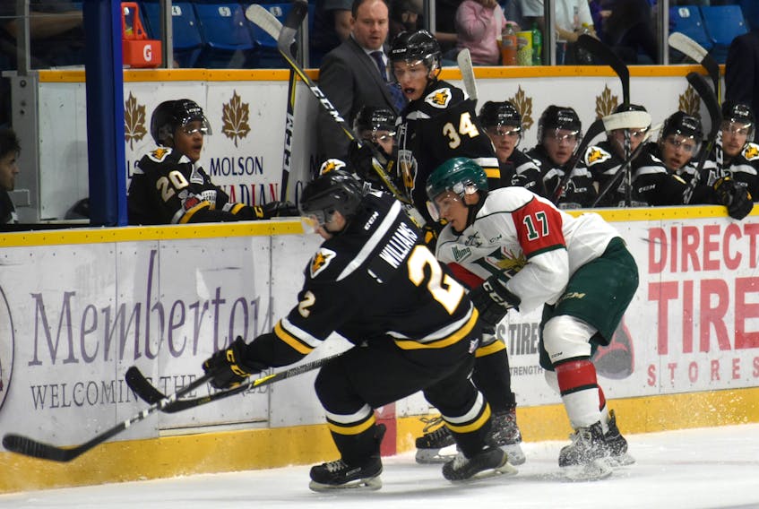 Cape Breton Screaming Eagles hopeful Kinnon Williams, left, is hounded by Halifax Mooseheads prospect Sonny Kabatay during Sunday’s pre-season Québec Major Junior Hockey League game between the Nova Scotia rivals before 1,053 fans at Centre 200 in Sydney. Williams and Kabatay, who were teammates with the Cape Breton Unionized Tradesmen last season, are among the many young players trying to crack a major junior teams’ lineup during the summer training camps. The Screaming Eagles defeated the Moosehead, 5-1.