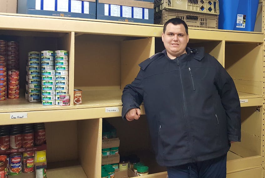 James MacLeod, a volunteer with the Glace Bay Food Bank, stands inside a storage room at the organization. Behind him is an empty shelf, one of many that needs to be filled during the annual fall food drive on Sept. 29.