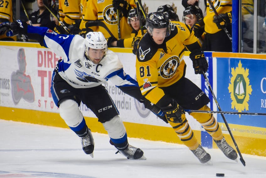 In this file photo, Mathias Laferrière, right, of the Cape Breton Screaming Eagles works his way around Bailey Webster of the Saint John Sea Dogs during Quebec Major Junior Hockey League action at Centre 200 in March. The St. Louis Blues prospect will be leaned upon to provide offence for the Screaming Eagles as the team begins the regular season on Friday.