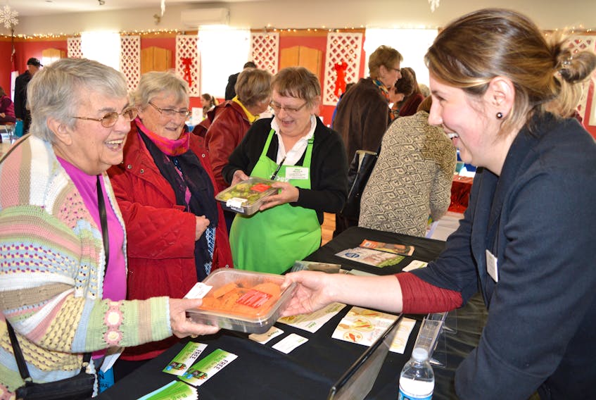 Katelyn Bourgeois, right, a dietician at Sobeys in Glace Bay, shows some healthy eating ideas to, from the left, Laraine Penney and her friend Patricia Rosnok, both of Glace Bay, while Sobeys community room coordinator Alberta White looks on during a seniors expo recently held at the Glace Bay Seniors and Pensioners Club. Bourgeois said most questions were on preparing healthy meals and preventing food waste. Penney said she was at the expo because she attended one two years ago and really enjoyed it. (Sharon Montgomery-Dupe/Cape Breton Post)
