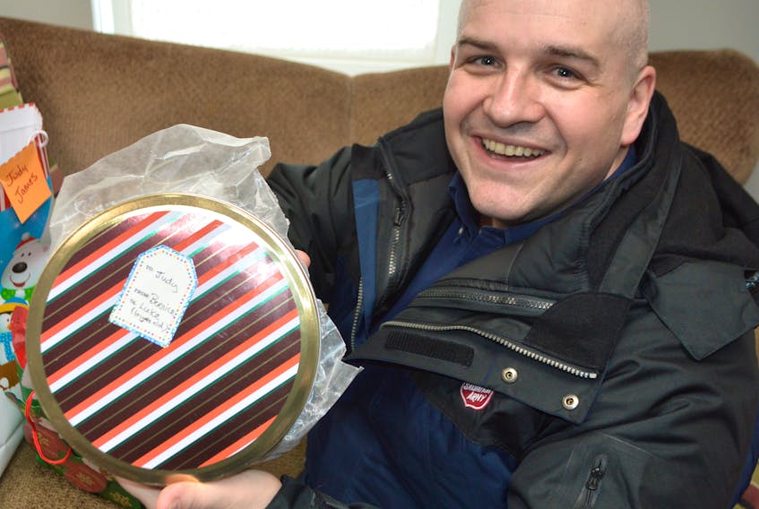 Major Corey Vincent of the Salvation Army in Sydney holds cookies and some Christmas gifts that were dropped off for Judy James, a Sydney senior spending Christmas alone. Vincent said after a story in the Cape Breton Post featured James and another lonely senior in North Sydney, the response from people wanting to help has been amazing.