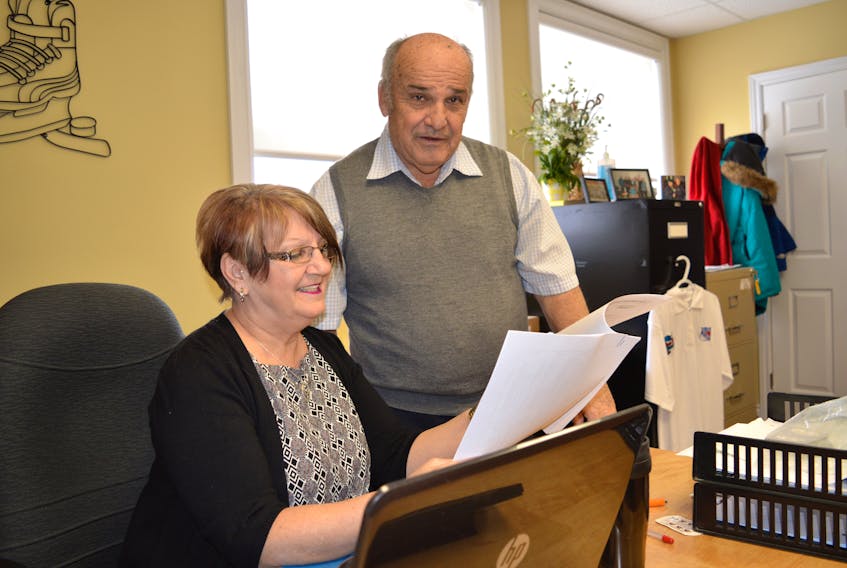Richie Warren, chair of the 29th annual Vince Ryan Memorial Hockey Tournament, goes over details about the 2018 event with Helen Hynes, logistics co-ordinator. The province has provided $30,000 for the tournament.