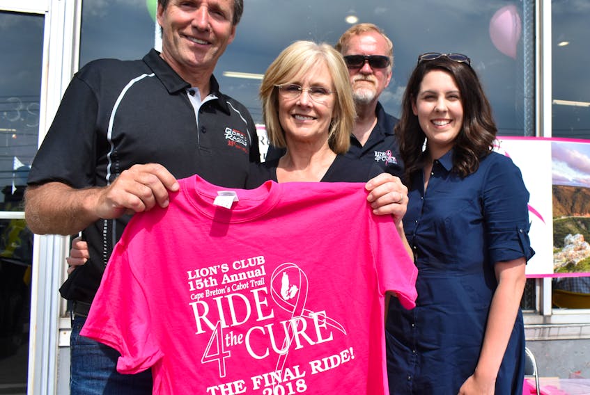 Gordon MacDonald, from left, and his wife, Mary Prince, hold the T-shirt for the 15th and final Ride for the Cure during an open house at Gord’s Sports Centre on Reeves Street, Sydney on Thursday. Looking on are Bill Redmond of Ride for the Cure and Cheryl Marsh of the Cape Breton Regional Hospital Foundation, who were registering people for the upcoming charity motorcycle ride around the Cabot Trail, which is set to take place Aug. 4.