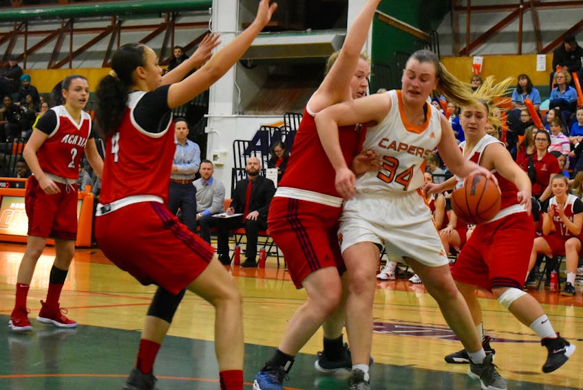 Cape Breton’s Hannah Brown is triple-teamed during the Capers 71-64 loss to the Acadia Axewomen in Atlantic University Sport women’s basketball action on Sunday at the Sullivan Fieldhouse at CBU. Brown, who is the conference’s leading scorer, still managed to net 27 points.