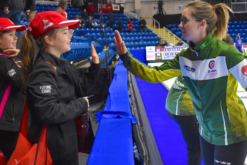 Northern Ontario skip Krista McCarville, from right, gave Molly MacIntosh and Jorja Stewart high-fives following her team’s extra-end win during the Scotties Tournament of Hearts at Centre 200.